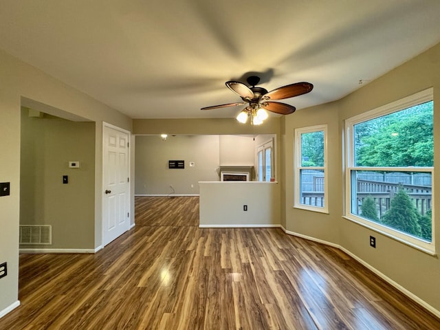 1317 Brook Ct, Erlanger, KY 41018 - unfurnished living room featuring ceiling fan, dark wood-style flooring, baseboards, and a fireplace