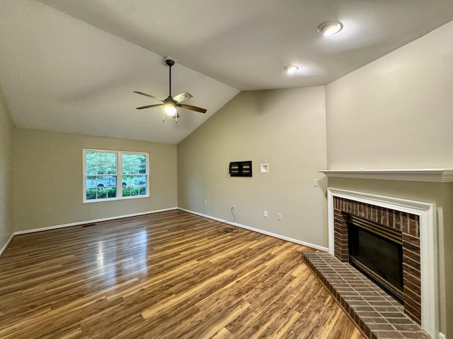1317 Brook Ct, Erlanger, KY 41018 - unfurnished living room featuring ceiling fan, wood finished floors, a brick fireplace, baseboards, and vaulted ceiling