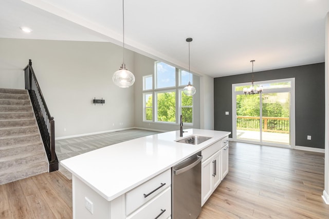 kitchen featuring a sink, dishwasher, plenty of natural light, white cabinets, and lofted ceiling