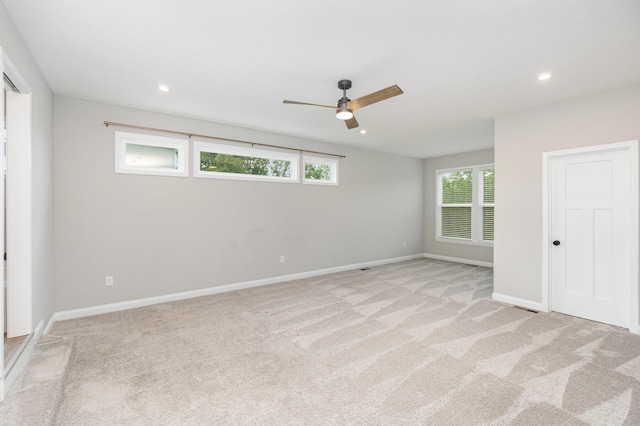 unfurnished bedroom with light colored carpet, baseboards, recessed lighting, and a ceiling fan