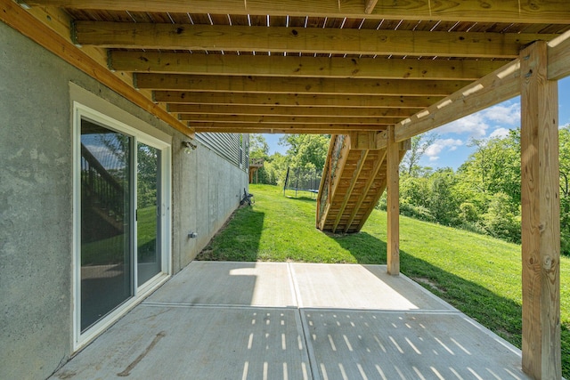 view of patio featuring stairs and a trampoline