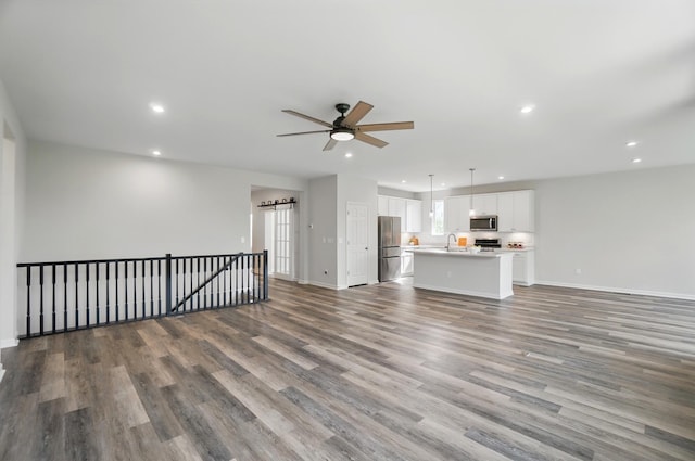 8042 Arcadia Blvd, Alexandria, KY 41001 - unfurnished living room with recessed lighting, wood finished floors, ceiling fan, baseboards, and a sink