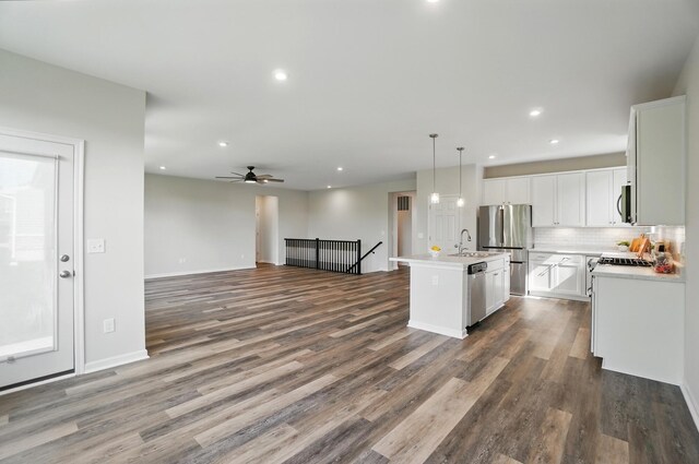 8042 Arcadia Blvd, Alexandria, KY 41001 - kitchen with stainless steel appliances, open floor plan, a sink, light countertops, and dark wood-style floors