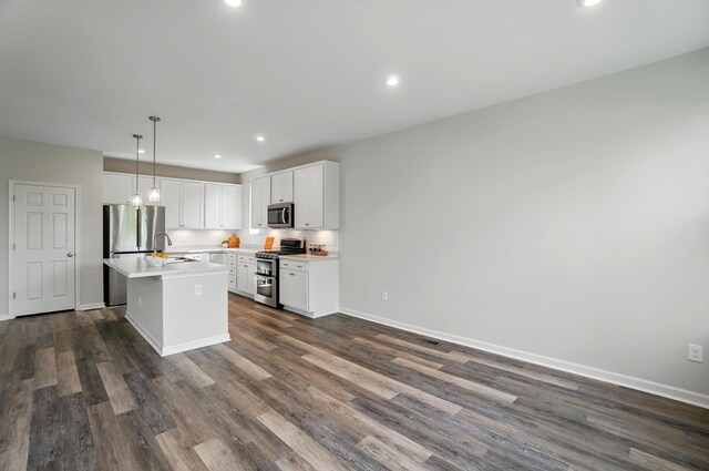 8042 Arcadia Blvd, Alexandria, KY 41001 - kitchen with appliances with stainless steel finishes, light countertops, an island with sink, dark wood finished floors, and tasteful backsplash