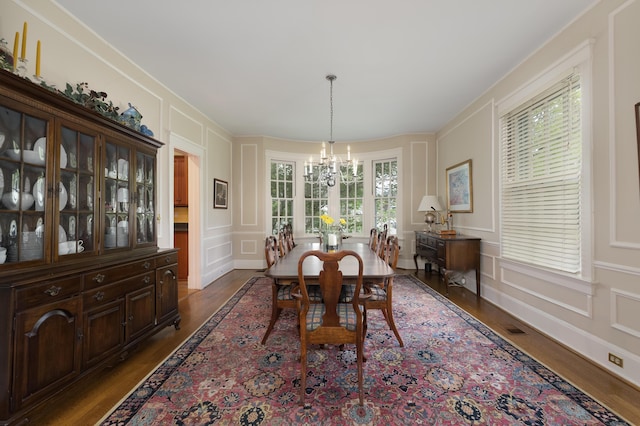 69 Linden Ave, Fort Thomas, KY 41075 - dining room featuring a decorative wall, dark wood-style floors, a chandelier, and crown molding