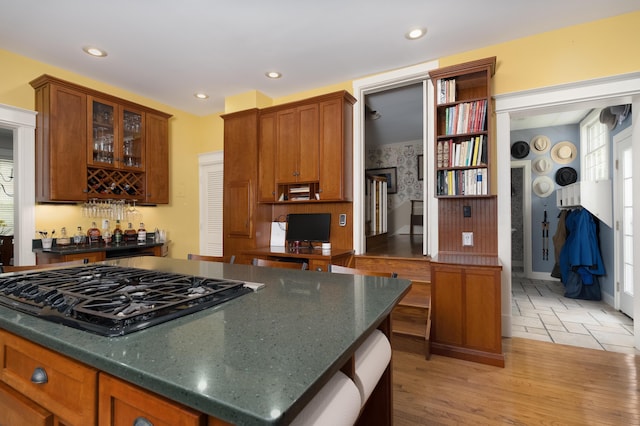 69 Linden Ave, Fort Thomas, KY 41075 - kitchen featuring cooktop, glass insert cabinets, recessed lighting, brown cabinets, and light wood-style flooring