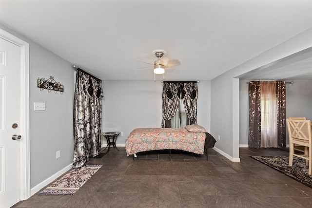 sitting room featuring ceiling fan and baseboards