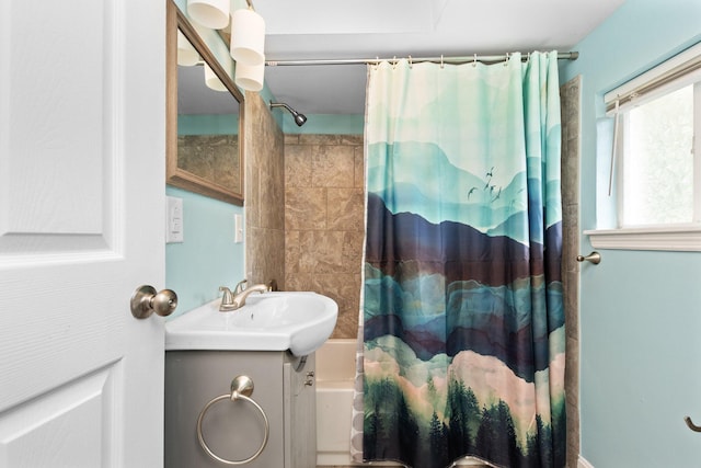 bathroom featuring shower / bath combo with shower curtain and vanity