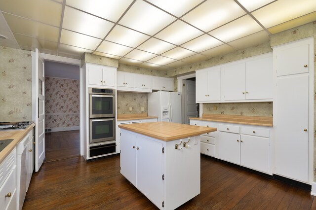 32 S Shaw Ln, Fort Thomas, KY 41075 - kitchen with wooden counters, white fridge with ice dispenser, stainless steel double oven, wallpapered walls, and dark wood finished floors