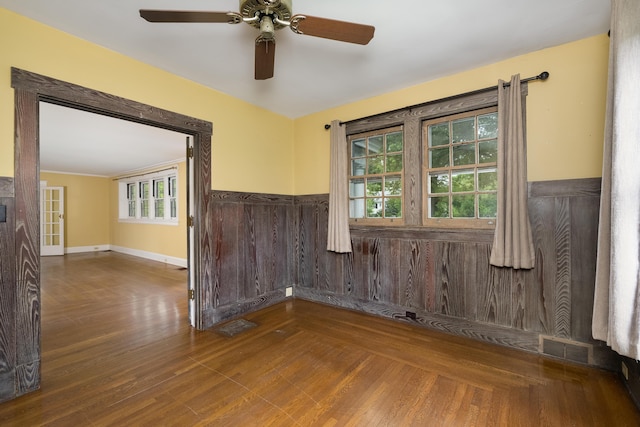 32 S Shaw Ln, Fort Thomas, KY 41075 - empty room featuring a ceiling fan, plenty of natural light, a wainscoted wall, and wood finished floors