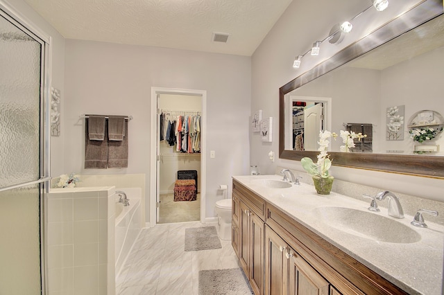 full bathroom featuring a bath, a spacious closet, marble look tile flooring, a stall shower, and double vanity