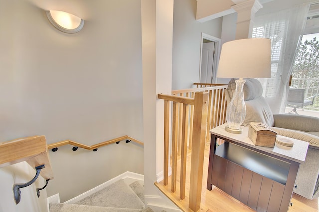 stairway with baseboards and decorative columns
