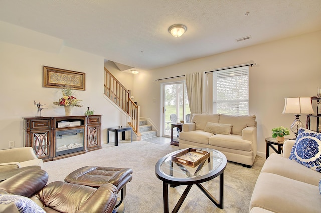 living room with light carpet and stairs