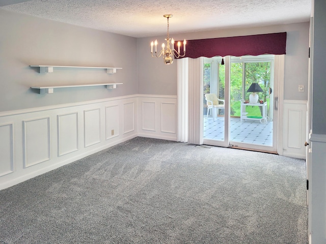 107 Timberlake Ave, Erlanger, KY 41018 - carpeted empty room featuring a chandelier, a textured ceiling, a wainscoted wall, and a decorative wall