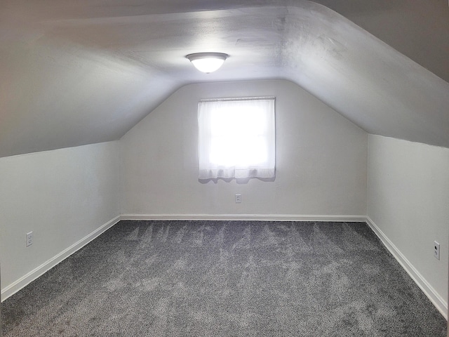 107 Timberlake Ave, Erlanger, KY 41018 - additional living space with dark colored carpet, lofted ceiling, and baseboards