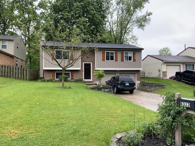 bi-level home with brick siding, an attached garage, and concrete driveway