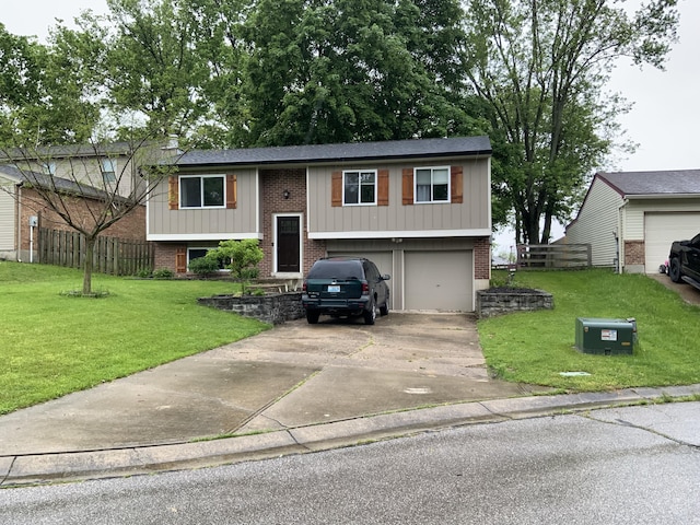 bi-level home featuring brick siding, an attached garage, and driveway