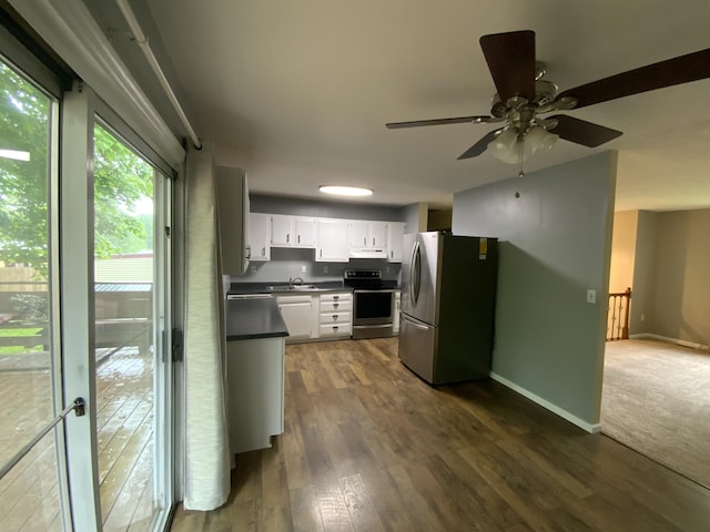 kitchen featuring appliances with stainless steel finishes, dark countertops, white cabinetry, ceiling fan, and dark wood-style floors