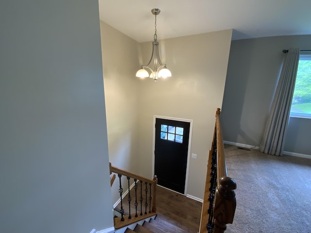 foyer with a chandelier and baseboards