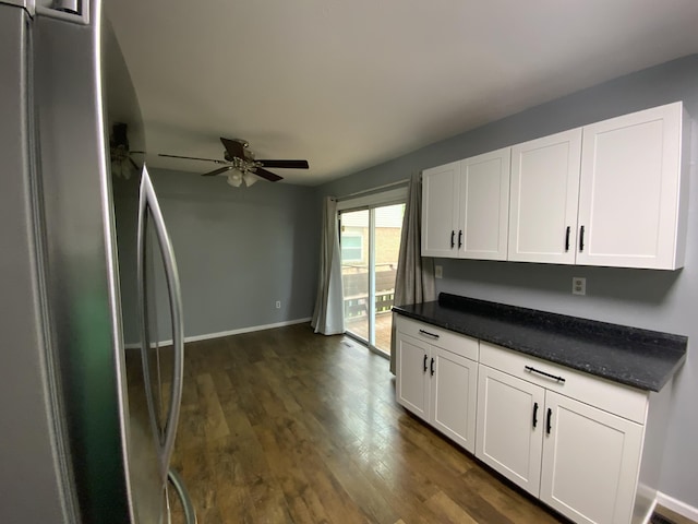 kitchen featuring freestanding refrigerator, white cabinetry, ceiling fan, dark wood-style floors, and baseboards