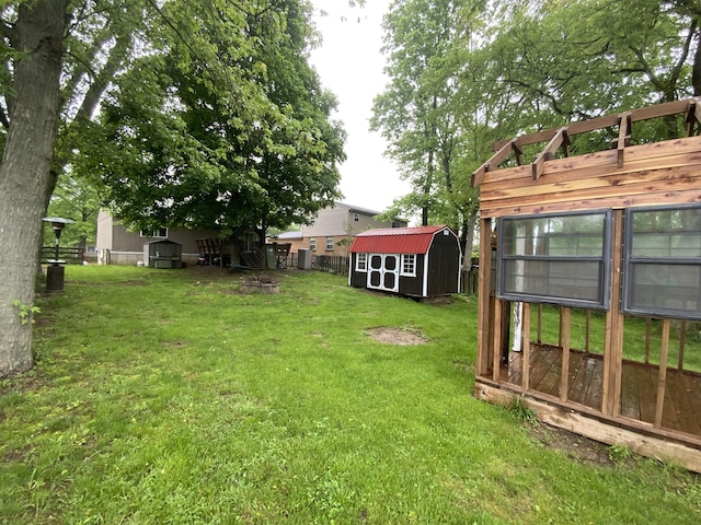 view of yard featuring a storage unit and an outbuilding