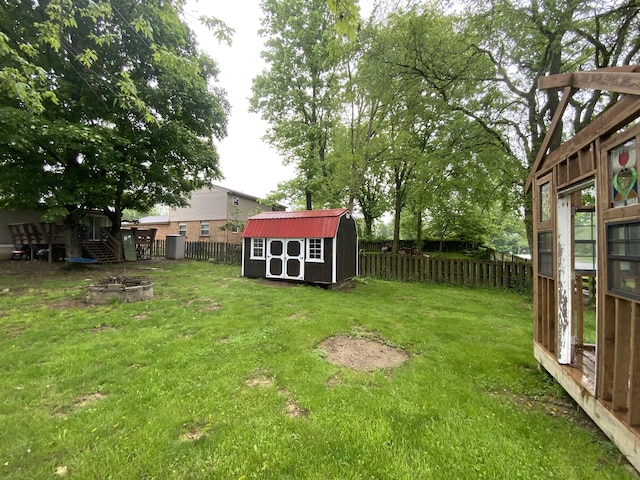 view of yard with a shed, an outdoor fire pit, and an outdoor structure