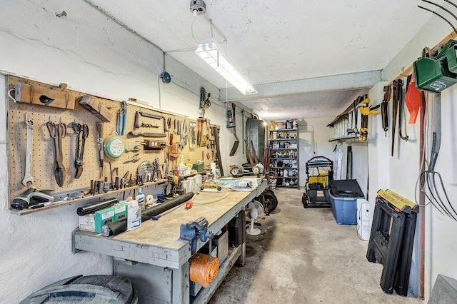 miscellaneous room with a workshop area and concrete flooring