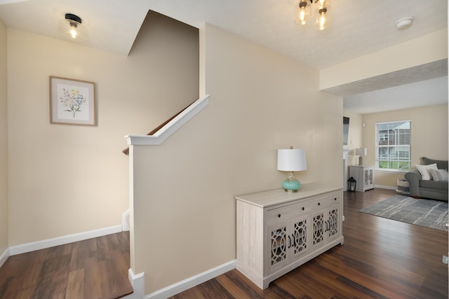 stairs featuring wood finished floors and baseboards