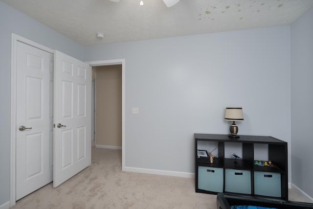 unfurnished bedroom with baseboards, carpet flooring, and ceiling fan
