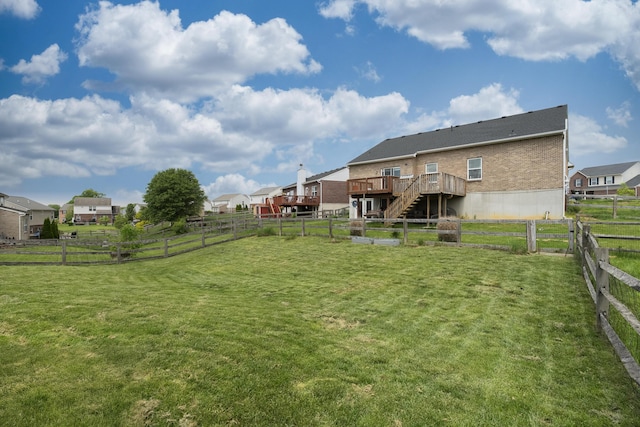 view of yard featuring a deck and stairs
