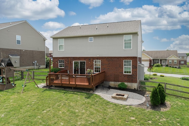 back of house featuring a fire pit, a deck, brick siding, and a patio area