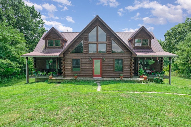 log cabin featuring covered porch, log exterior, and a front yard