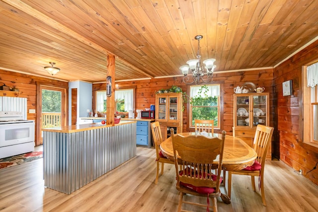 dining space featuring wooden ceiling, a chandelier, wood walls, and light wood-type flooring
