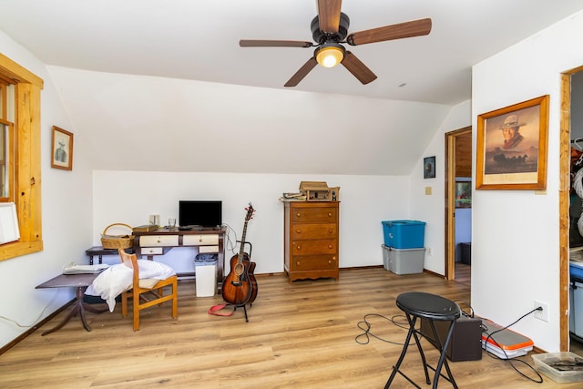 office area featuring vaulted ceiling, light wood-type flooring, and a ceiling fan