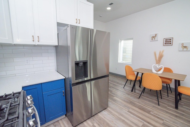 1510 Kavanaugh St, Covington, KY 41011 - kitchen featuring appliances with stainless steel finishes, backsplash, light wood-type flooring, light countertops, and white cabinetry