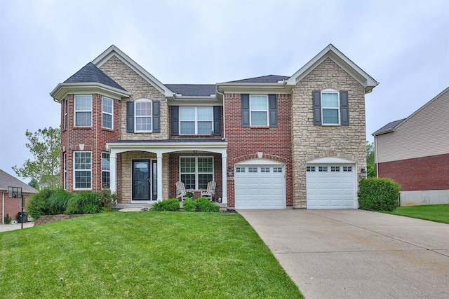 2011 Holderness Dr, Union, KY 41091 - view of front of home with concrete driveway, a garage, a front lawn, stone siding, and brick siding