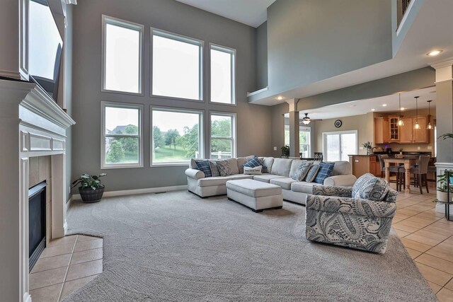 2011 Holderness Dr, Union, KY 41091 - living area with a tiled fireplace, light tile patterned floors, a towering ceiling, baseboards, and recessed lighting