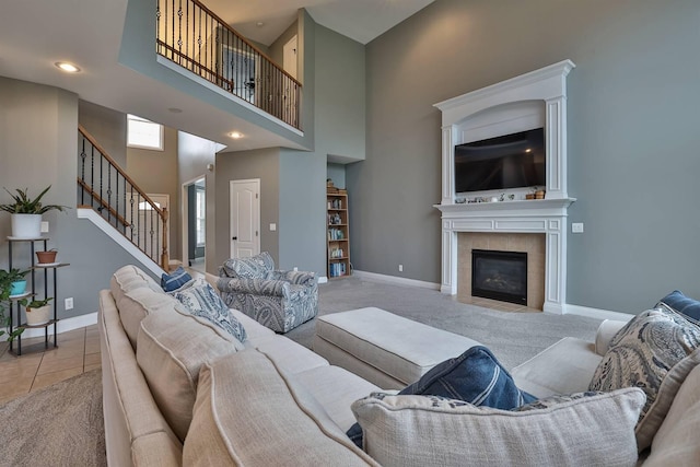 2011 Holderness Dr, Union, KY 41091 - living room featuring stairway, a fireplace, a towering ceiling, baseboards, and carpet