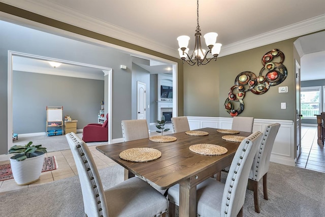 2011 Holderness Dr, Union, KY 41091 - dining room with light tile patterned floors, crown molding, a chandelier, light carpet, and a fireplace