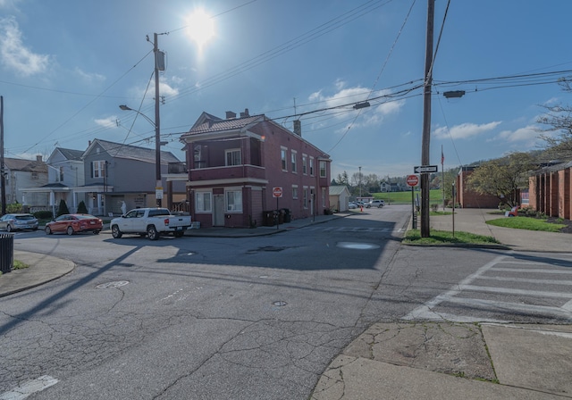 417 W 19th St, Covington, KY 41014 - view of asphalt road with traffic signs, a residential view, sidewalks, street lighting, and curbs