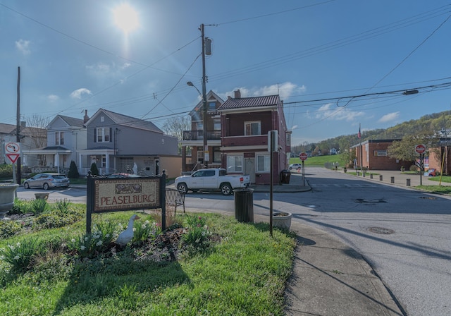 417 W 19th St, Covington, KY 41014 - view of asphalt road featuring traffic signs, a residential view, street lighting, and curbs