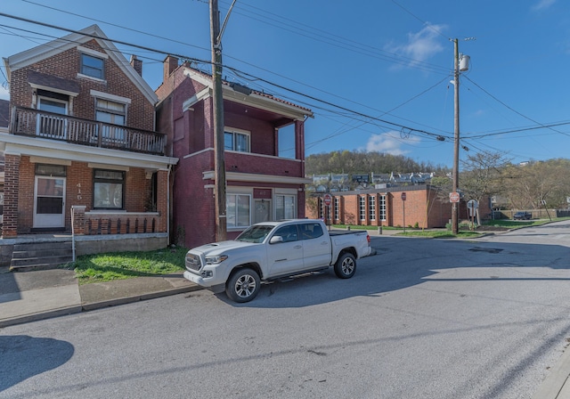417 W 19th St, Covington, KY 41014 - view of front facade with brick siding and a balcony