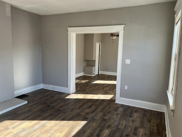 417 W 19th St, Covington, KY 41014 - spare room with dark wood finished floors, a ceiling fan, and baseboards