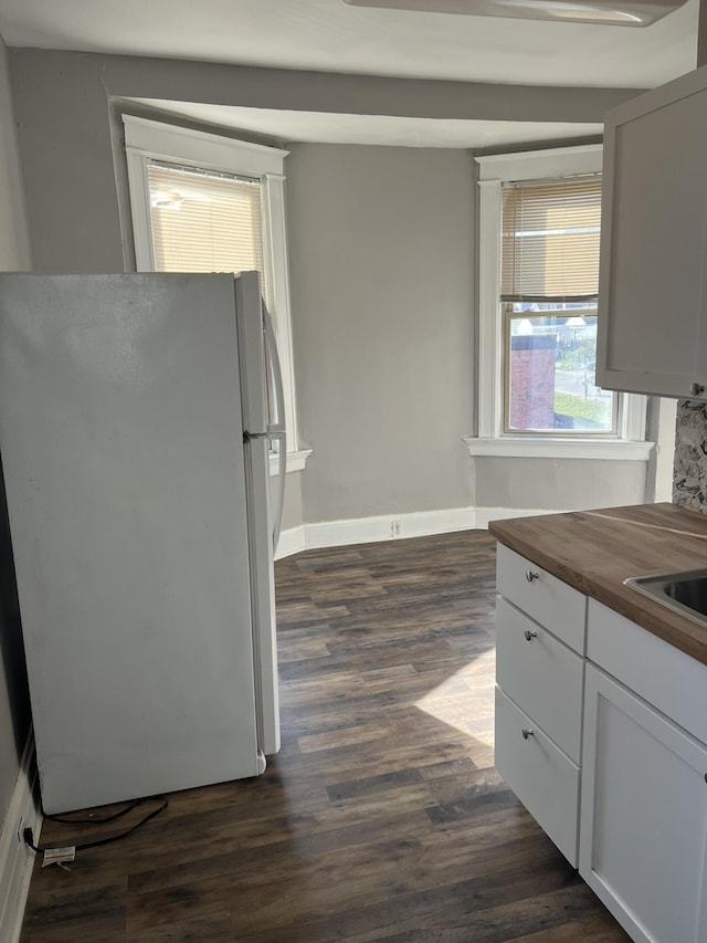 417 W 19th St, Covington, KY 41014 - kitchen featuring freestanding refrigerator, wooden counters, dark wood-style flooring, baseboards, and white cabinets
