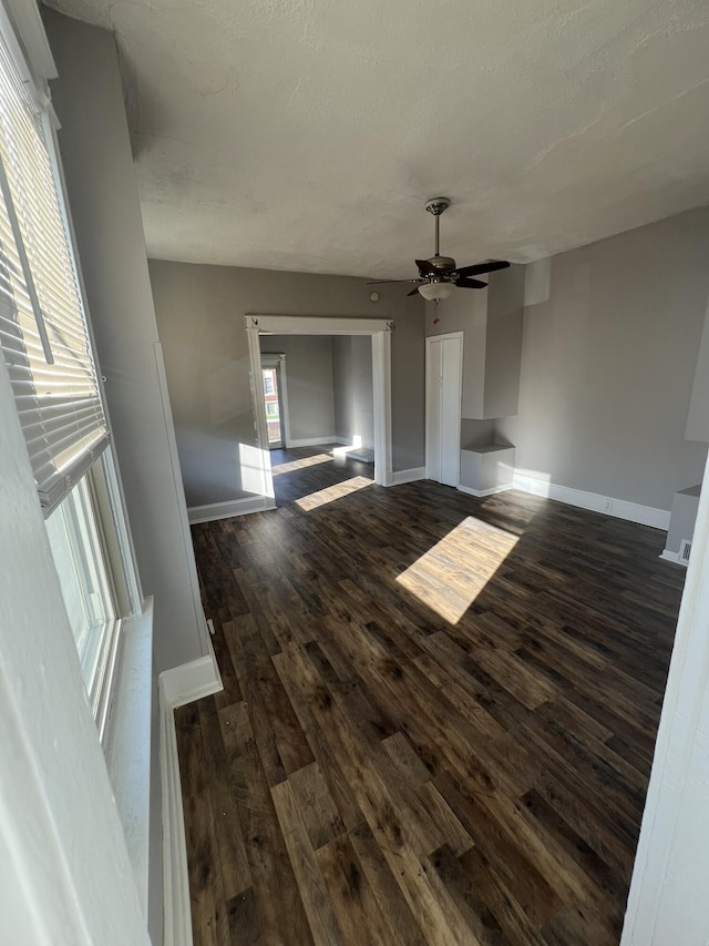 417 W 19th St, Covington, KY 41014 - unfurnished living room with dark wood finished floors, a ceiling fan, and baseboards
