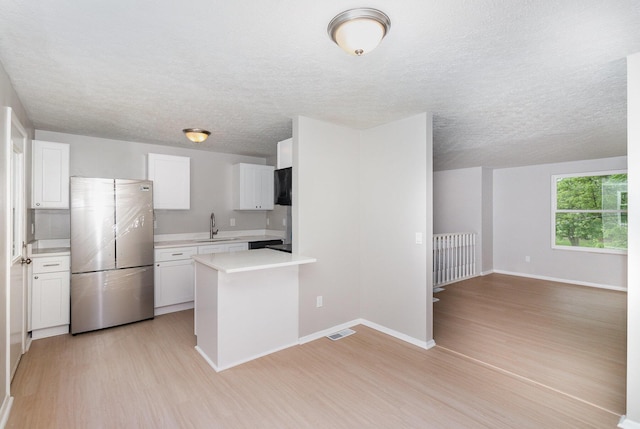 3492 Ridgewood Dr, Erlanger, KY 41018 - kitchen with freestanding refrigerator, light wood-type flooring, light countertops, a sink, and a textured ceiling
