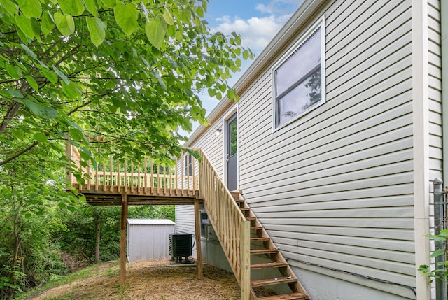 3492 Ridgewood Dr, Erlanger, KY 41018 - view of side of property featuring central AC, a wooden deck, stairs, and a shed