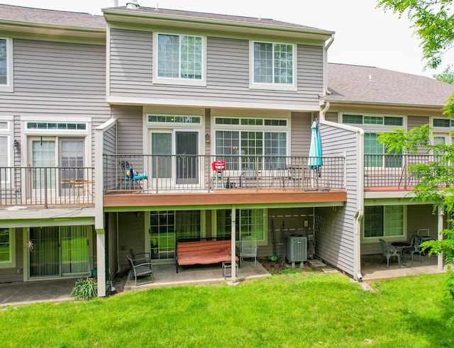 back of house featuring a patio area, a yard, and central AC unit