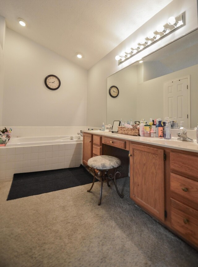 full bathroom with a bath and vanity