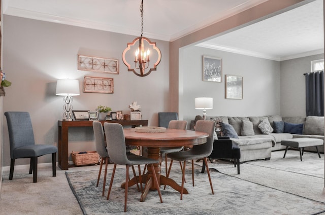 dining room with a chandelier, ornamental molding, and light carpet